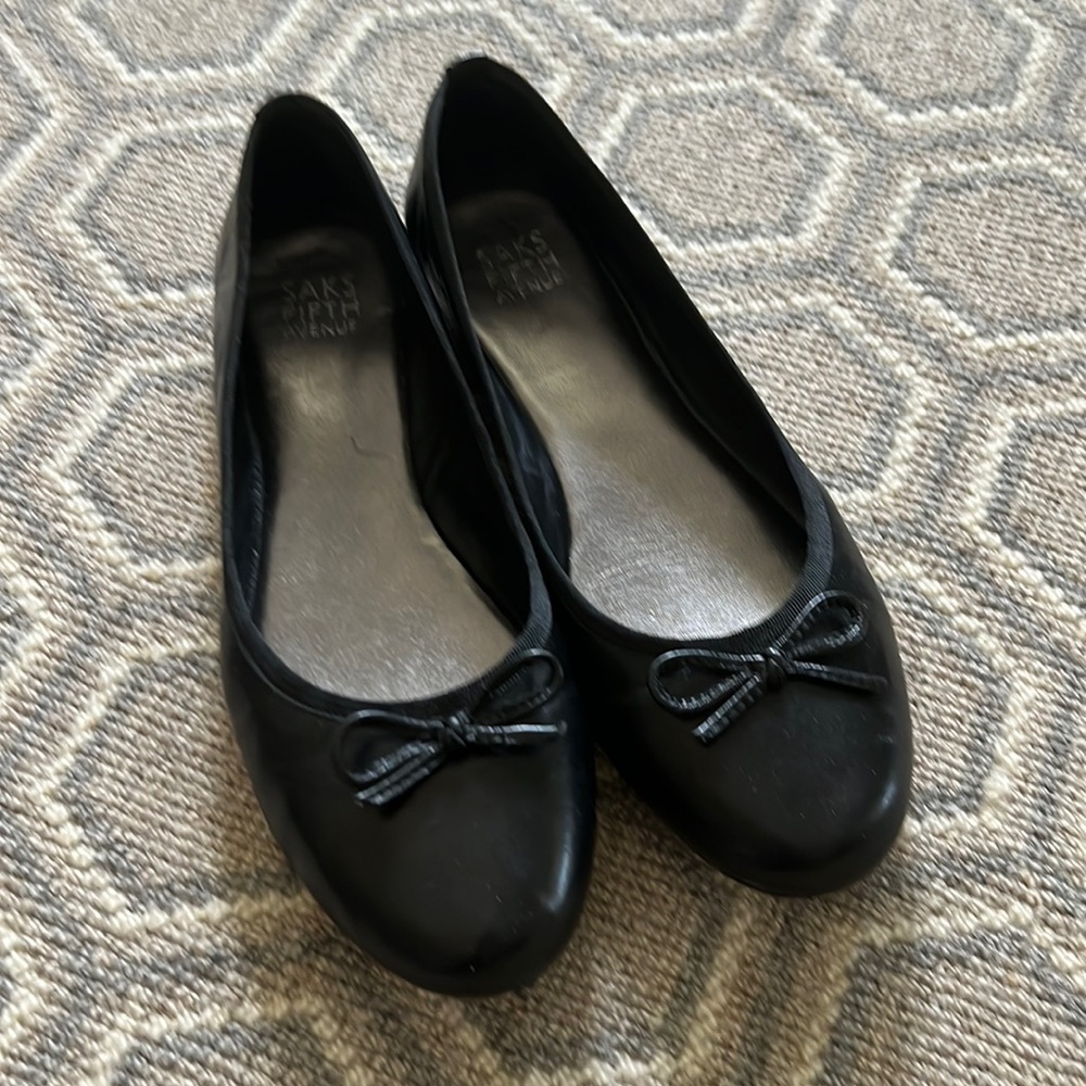Saks 5th Avenue black ballets flats.